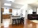 Kitchen with an island, wood cabinets, stainless steel appliances, and hardwood floors at 8408 Canterbury Lake Blvd, Tampa, FL 33619