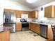 Kitchen with stainless steel appliances and light wood cabinets at 8408 Canterbury Lake Blvd, Tampa, FL 33619