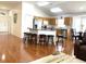 Open concept kitchen with island, hardwood floors, and stainless steel appliances at 8408 Canterbury Lake Blvd, Tampa, FL 33619