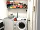 Laundry room with washer, dryer, and shelving at 8408 Canterbury Lake Blvd, Tampa, FL 33619