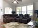 Spacious living room with brown reclining sectional sofa at 8408 Canterbury Lake Blvd, Tampa, FL 33619
