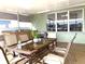 Screened patio with dining table and seating at 8408 Canterbury Lake Blvd, Tampa, FL 33619