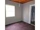 Simple bedroom with carpet, window, and access to bathroom at 905 10Th Sw St, Ruskin, FL 33570