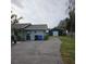 Home's side view, showing a detached garage and driveway at 905 10Th Sw St, Ruskin, FL 33570