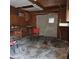 Unfinished garage with workbench and two chairs at 905 10Th Sw St, Ruskin, FL 33570