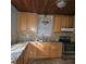 L-shaped kitchen with wood cabinets and granite countertops at 905 10Th Sw St, Ruskin, FL 33570