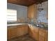 L-shaped kitchen with wood cabinets and granite countertops at 905 10Th Sw St, Ruskin, FL 33570