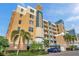 Exterior view of a condo building with palm trees and parking at 960 Starkey Rd # 5301, Largo, FL 33771