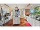 Kitchen with white cabinets, granite counters, and island at 960 Starkey Rd # 5301, Largo, FL 33771
