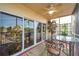 Screened lanai with glass doors, table, chairs, and scenic view at 960 Starkey Rd # 5301, Largo, FL 33771