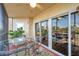 Private lanai with glass doors, table, chairs, and scenic view at 960 Starkey Rd # 5301, Largo, FL 33771
