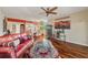Bright living room with hardwood floors, red leather couch, and a wine rack at 960 Starkey Rd # 5301, Largo, FL 33771