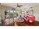Living room with hardwood floors, balcony access, and red leather couch at 960 Starkey Rd # 5301, Largo, FL 33771