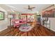 Living room features hardwood floors, a red leather couch, and a view into the dining area at 960 Starkey Rd # 5301, Largo, FL 33771