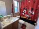 Clean bathroom with shower/tub combo, single sink vanity, and Mickey Mouse themed decor at 9822 Carlsdale Dr, Riverview, FL 33578