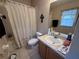 Bathroom with tub shower combo, single sink vanity, and neutral decor at 9822 Carlsdale Dr, Riverview, FL 33578
