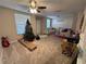Living room with carpeted floors, a Christmas tree, and a ceiling fan at 9822 Carlsdale Dr, Riverview, FL 33578
