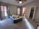Main bedroom with carpeted floors, ceiling fan, and access to bathroom and closet at 9822 Carlsdale Dr, Riverview, FL 33578