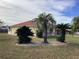 Side view of a house with palm trees and a well-maintained lawn at 10412 Ireland St, Spring Hill, FL 34608