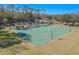 Basketball court with players, surrounded by trees at 12113 Marblehead Dr, Tampa, FL 33626