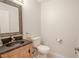 Simple half bathroom with pedestal sink and wood vanity at 12113 Marblehead Dr, Tampa, FL 33626