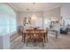 Bright dining room features a round table with six chairs, an elegant chandelier, and a large window with plantation shutters at 12113 Marblehead Dr, Tampa, FL 33626