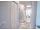 Long hallway with light walls, white closets, and a runner rug leading to other rooms at 12113 Marblehead Dr, Tampa, FL 33626