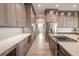 Open kitchen with modern cabinetry, stainless steel appliances, and herringbone backsplash at 12113 Marblehead Dr, Tampa, FL 33626