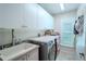 Bright laundry room featuring built-in cabinets and a utility sink at 12113 Marblehead Dr, Tampa, FL 33626