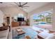 Living room with vaulted ceiling, fireplace, and sliding doors to the pool at 12113 Marblehead Dr, Tampa, FL 33626