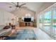 Living room with vaulted ceiling, brick wall, sliding doors to pool and lanai at 12113 Marblehead Dr, Tampa, FL 33626