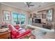 Living room features red sofa, built-in shelving, and a view of the golf course at 12113 Marblehead Dr, Tampa, FL 33626