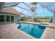 Relaxing screened pool and spa with paver deck and golf course views at 12113 Marblehead Dr, Tampa, FL 33626