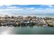 Aerial view of a coastal neighborhood with waterfront access and boats at 12116 Lagoon Ln, Treasure Island, FL 33706