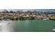 Wide aerial view of waterfront homes and boats along a calm waterway at 12116 Lagoon Ln, Treasure Island, FL 33706