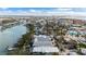 Aerial view of house and neighborhood near the beach and waterway at 12116 Lagoon Ln, Treasure Island, FL 33706