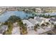 Aerial view of a waterfront home with private dock and surrounding houses at 12116 Lagoon Ln, Treasure Island, FL 33706