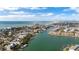 Aerial view of waterfront home, beach, and surrounding neighborhood at 12116 Lagoon Ln, Treasure Island, FL 33706