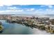 Aerial view showcasing waterfront homes, boats, and the coastline at 12116 Lagoon Ln, Treasure Island, FL 33706