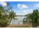 Waterfront backyard with lush landscaping and private dock access at 12116 Lagoon Ln, Treasure Island, FL 33706