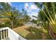Landscaped backyard with lush tropical plants and waterfront views at 12116 Lagoon Ln, Treasure Island, FL 33706