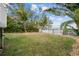 Landscaped backyard with tropical plants and waterfront views at 12116 Lagoon Ln, Treasure Island, FL 33706