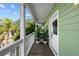 Private balcony with planters and white railing at 12116 Lagoon Ln, Treasure Island, FL 33706