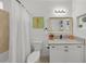 Clean bathroom with a bathtub, granite countertop, and white cabinets at 12116 Lagoon Ln, Treasure Island, FL 33706