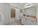 Clean bathroom with a bathtub, granite countertop, and white cabinets at 12116 Lagoon Ln, Treasure Island, FL 33706