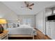 Spacious bedroom with king-size bed, hardwood floors, and ceiling fan at 12116 Lagoon Ln, Treasure Island, FL 33706