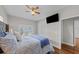 Bright bedroom with a comfortable bed, large TV, and ample closet space at 12116 Lagoon Ln, Treasure Island, FL 33706