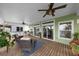Relaxing outdoor deck with seating area, ceiling fan, and sliding glass doors at 12116 Lagoon Ln, Treasure Island, FL 33706