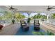 Relaxing waterfront deck with seating and ceiling fans at 12116 Lagoon Ln, Treasure Island, FL 33706