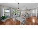 Bright dining room with white table, hardwood floors, and access to deck at 12116 Lagoon Ln, Treasure Island, FL 33706